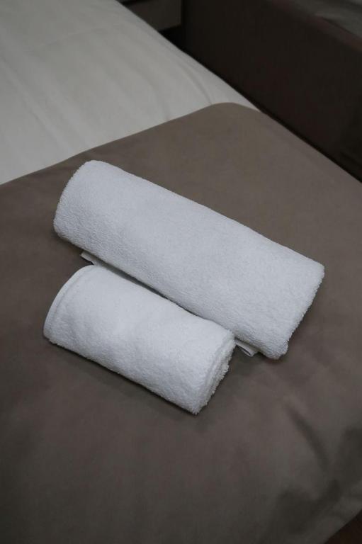 two rolls of white towels sitting on a table at Отель Кочевник in Astana