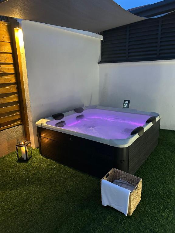 a large purple bath tub sitting in the grass at Lelo Sunset Spa, Romantic Garden Apartment with Private Jacuzzi in Zadar