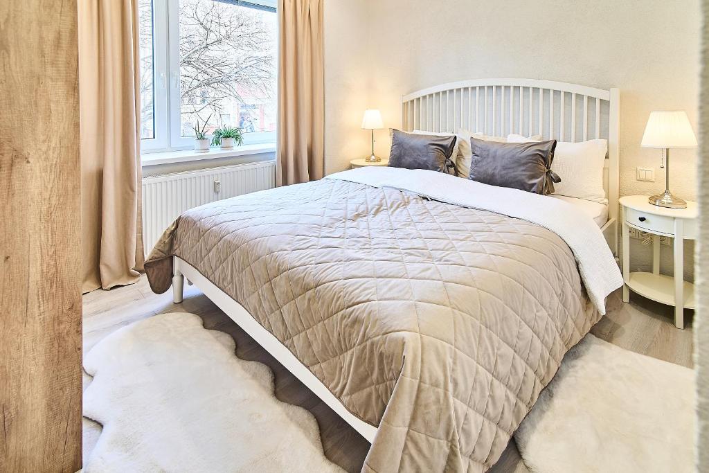 a bedroom with a large bed and a window at Smart apartmány Prešov in Prešov