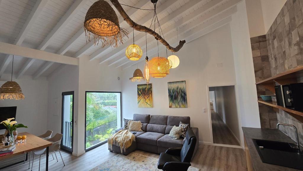 a living room with a couch and a table at Vulcânica - Boutique Suites in Furnas São Miguel in Furnas