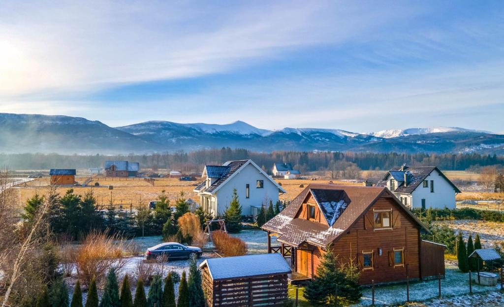 a small village with mountains in the background at Zielona Dolinka in Kostrzyca