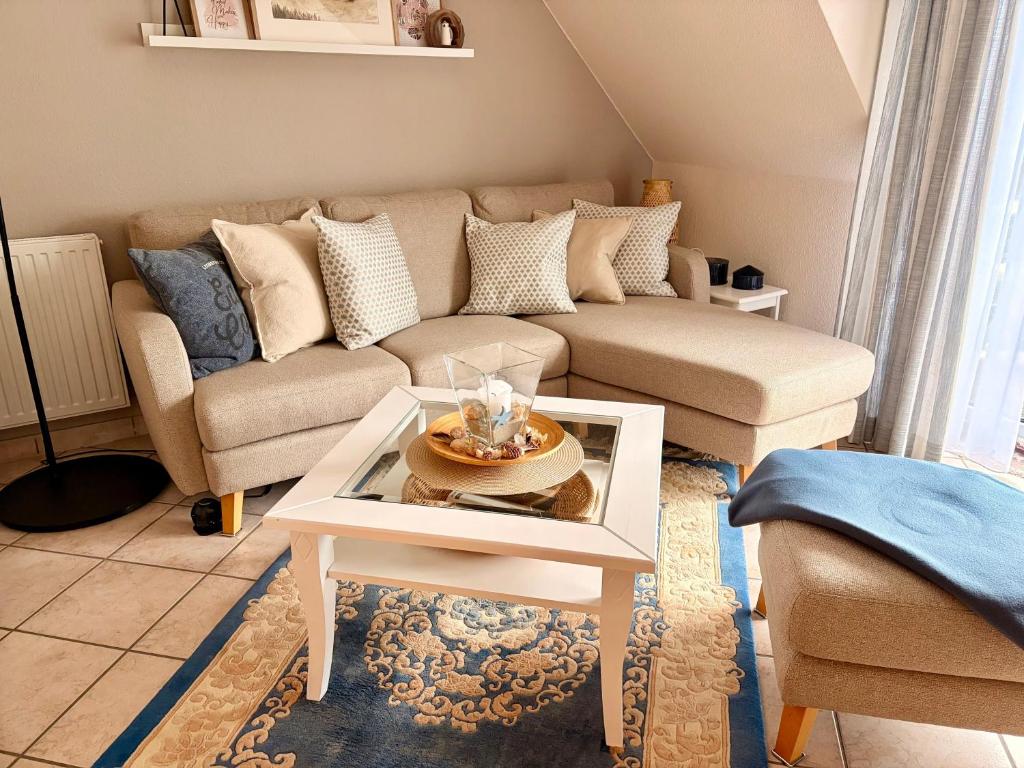 a living room with a couch and a table at Strandbrise App 17 in Neuhaus
