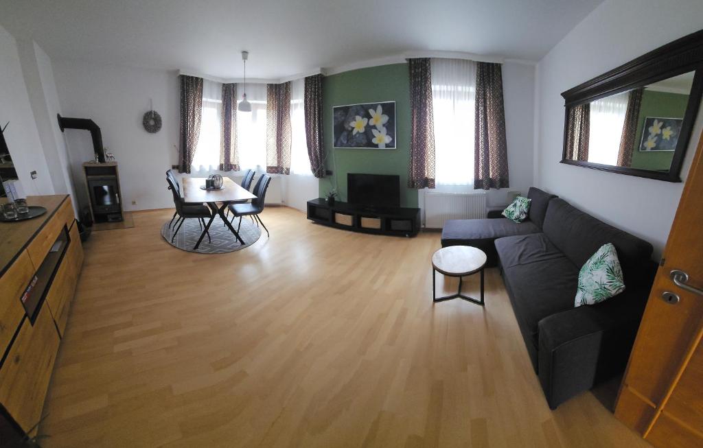 a living room with a couch and a table at Appartement July in Innsbruck