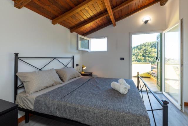 ein Schlafzimmer mit einem großen Bett und einem großen Fenster in der Unterkunft Camera SIRINA in Fezzano