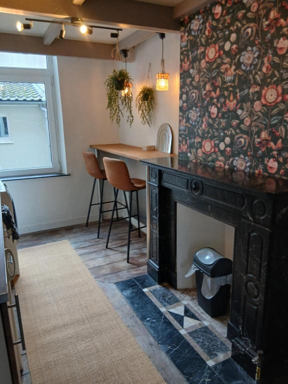 a dining room with a table and a fireplace at Urban Maghin in Liège