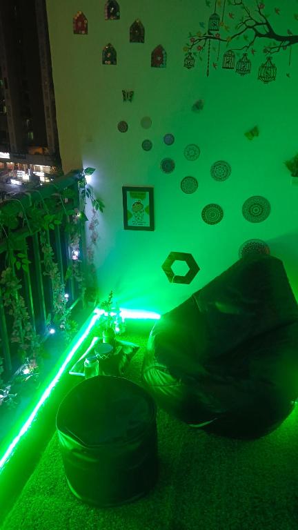 a room with a green light on the wall at NXone STUDIO APARTMENT in Noida