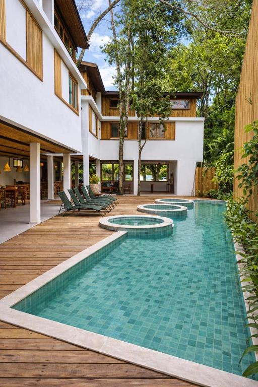an infinity pool in the backyard of a house at Pousada Villa Gûyrá in Trancoso