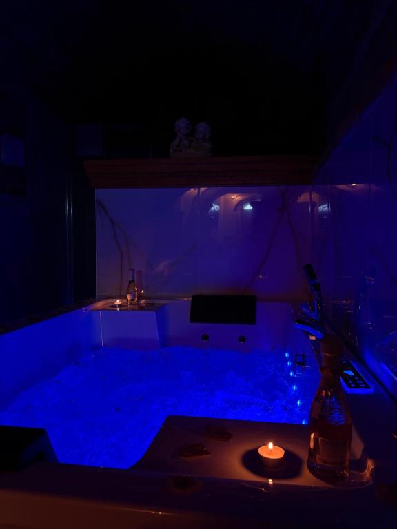 a dark room with a table with a candle in it at Rabat Home Luxury in Tursi