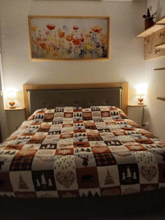 a bedroom with a bed with a quilt on it at Il Mughetto in Aosta