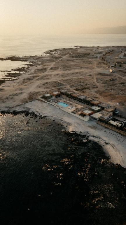 an aerial view of an island in a body of water at Roushan Resort Salalah Mirbat in Mirbāţ