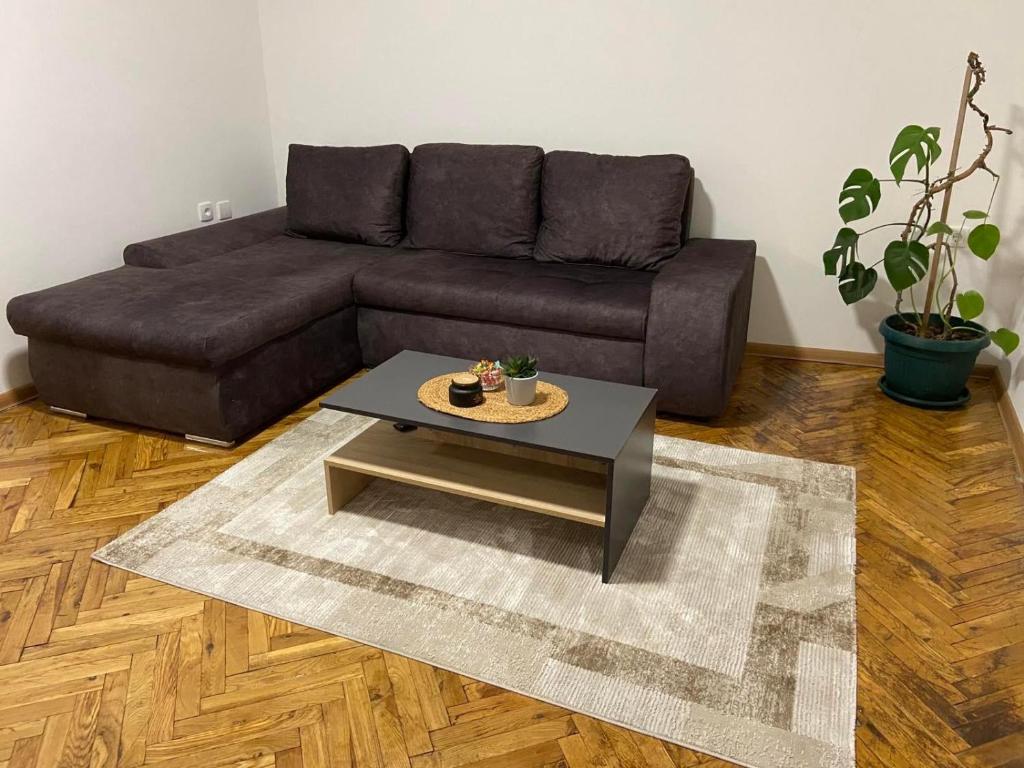 a living room with a couch and a coffee table at Venus 1 in Kula