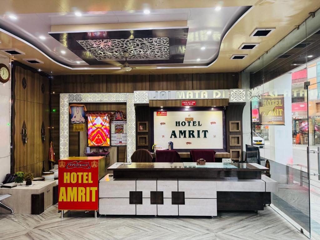 a hotel lobby with a hotel entrance at Hotel Amrit in Bharwain