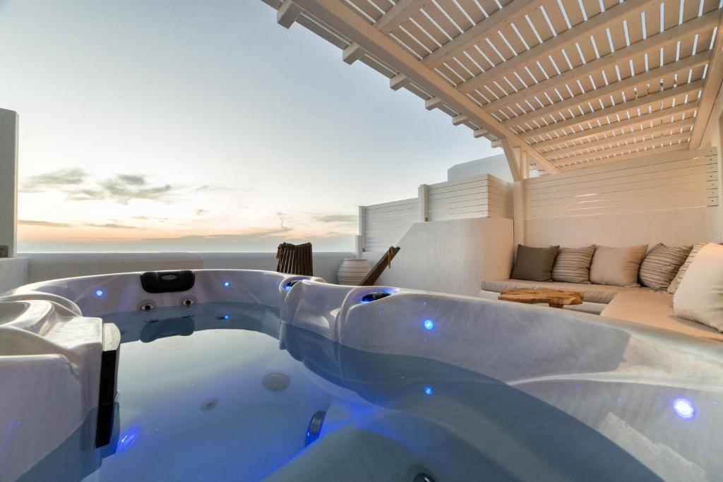 a bath tub in the middle of a living room at Anna Platanou Suites in Agia Irini Paros