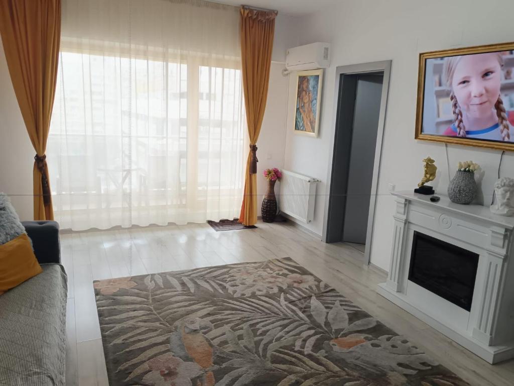 a living room with a fireplace and a couch at Silver De Lux in Bacău