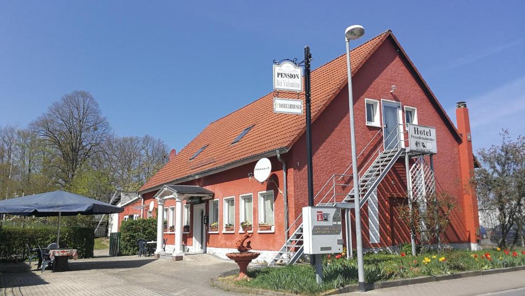 a red brick building with a sign on it at Pension Bei Valentina in Wertheim