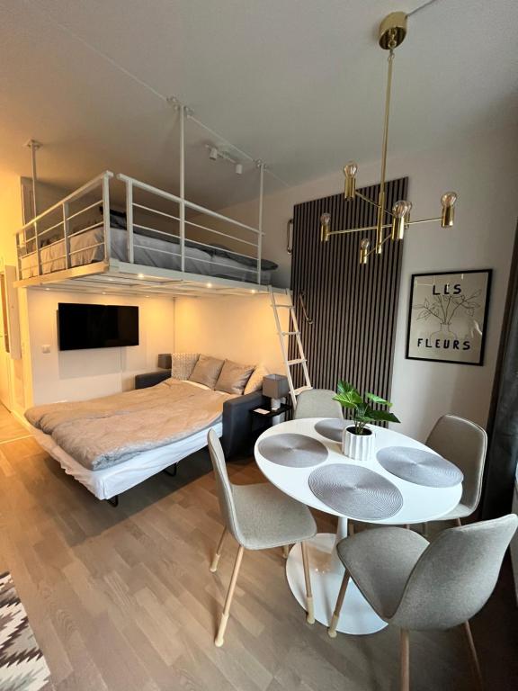 a bedroom with a bunk bed and a table and chairs at Nordic NOVA Studio in Stockholm
