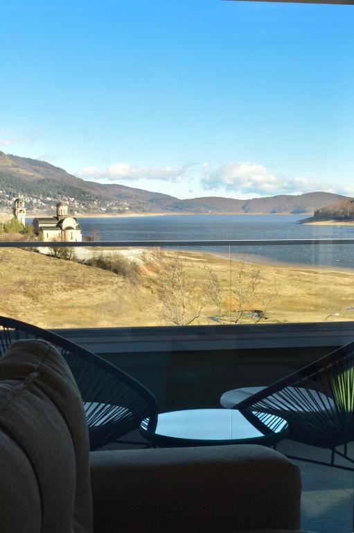 a room with a view of a body of water at Vila Ella Mavrovo in Mavrovo