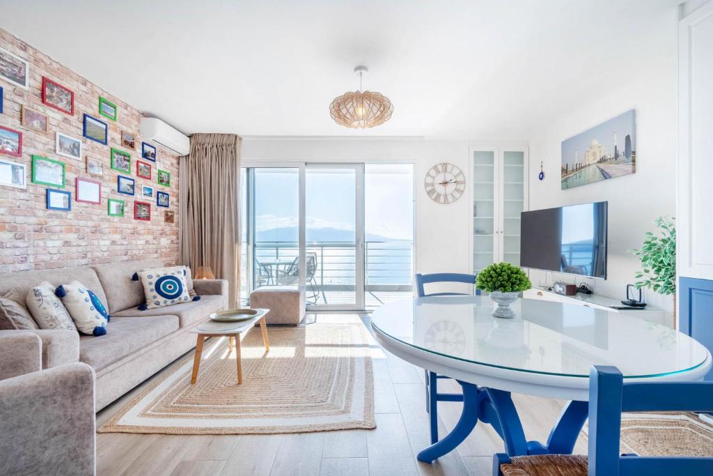 a living room with a table and a couch at Blue Eye Apartment in Sarandë
