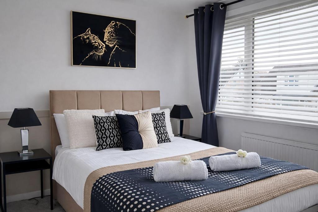 a bedroom with a bed with pillows and a window at That's Amore House 3 bedroom house with parking walking distance to Sandbach town in Sandbach