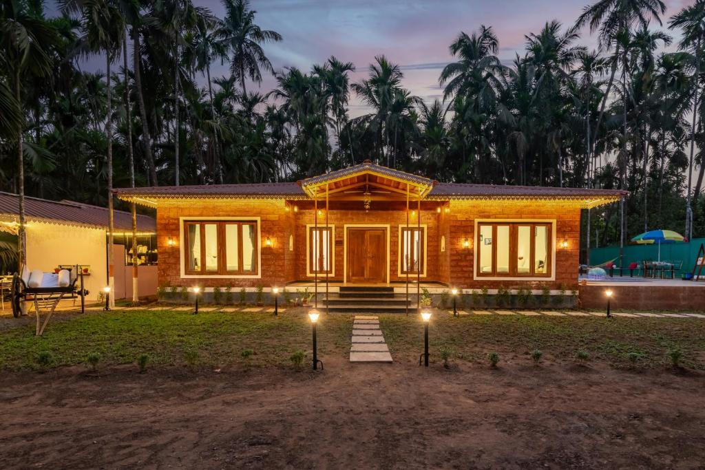 a small house with lights in front of it at Cabanas Retreat in Revadanda
