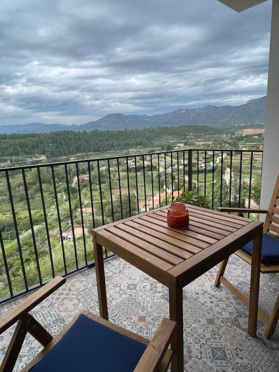 a wooden table on a balcony with a view at Les Casetes in La Senia