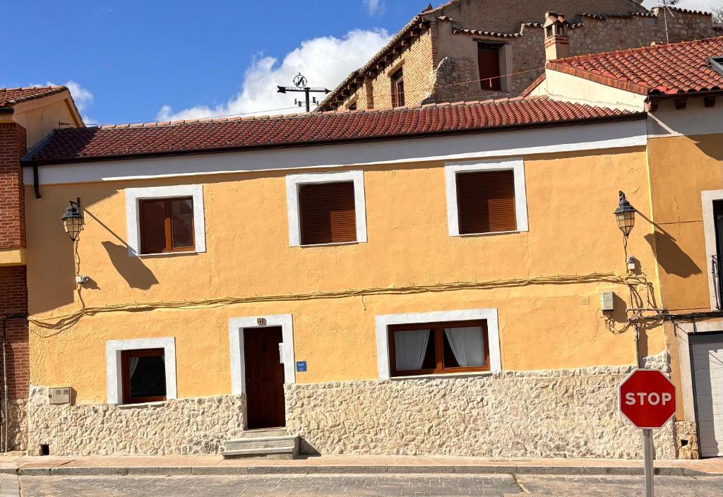 a building on a street with a stop sign at El Capricho de Nunu SIMANCAS in Simancas