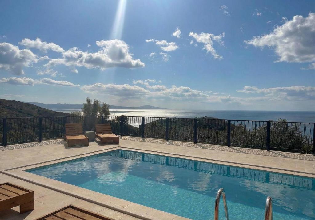a swimming pool with a view of the ocean at Petres Luxury Villas with heated private pool in Agia Galini