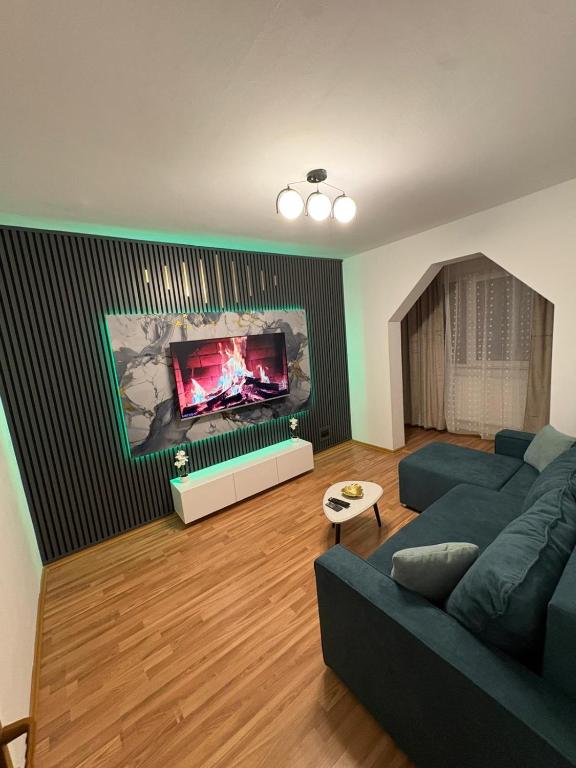a living room with a blue couch and a fireplace at Apartament Eric in Mangalia