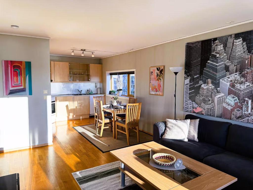 a living room with a couch and a table at Nordic Comfort Apartment in Trondheim