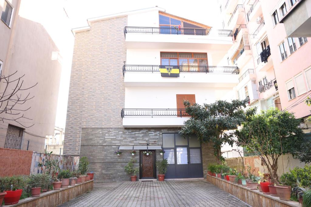 a white building with a door and a balcony at Guesthouse Alemannia in Berat