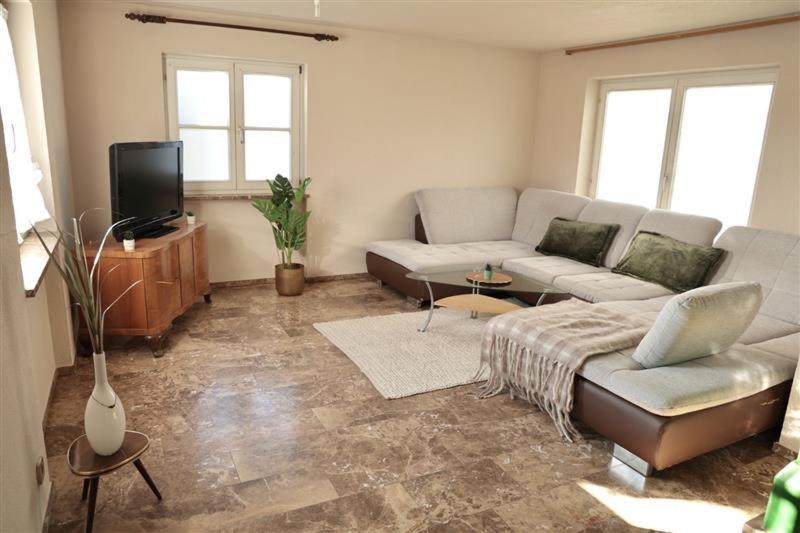 a living room with a couch and a tv at Zurück zur Wurzel in Karsau
