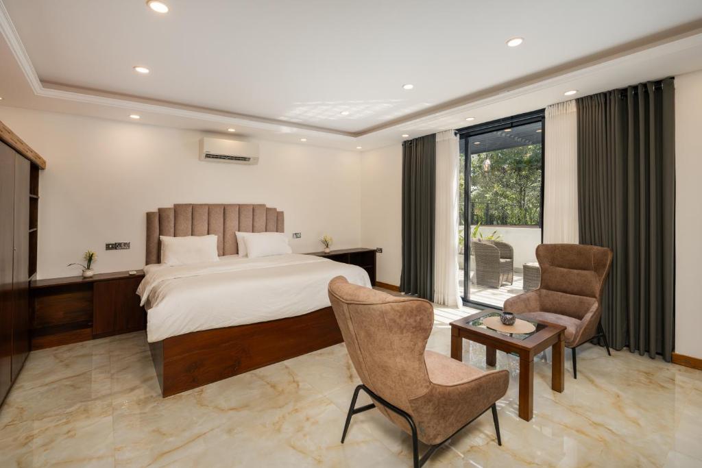 a bedroom with a bed and a table and chairs at Lasantha's Residence in Kadawata