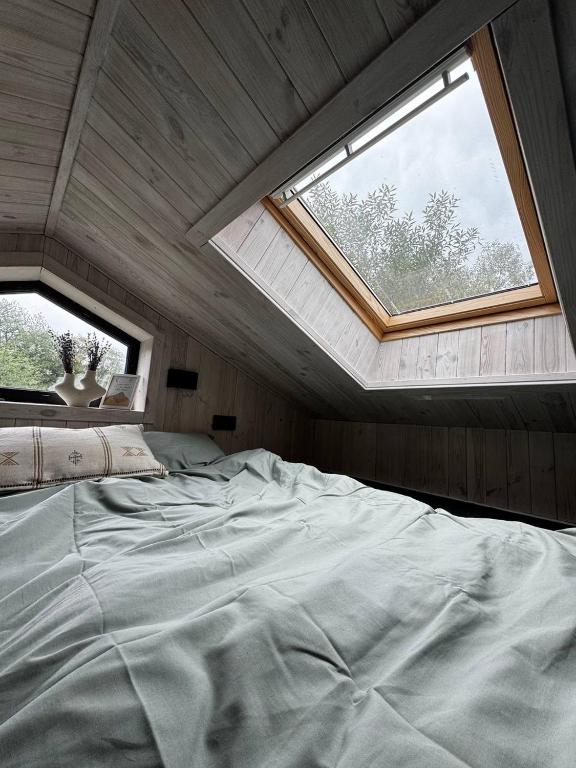 a large bed in a room with a window at Osho house Karpaty in Ilʼtsya Dolishna