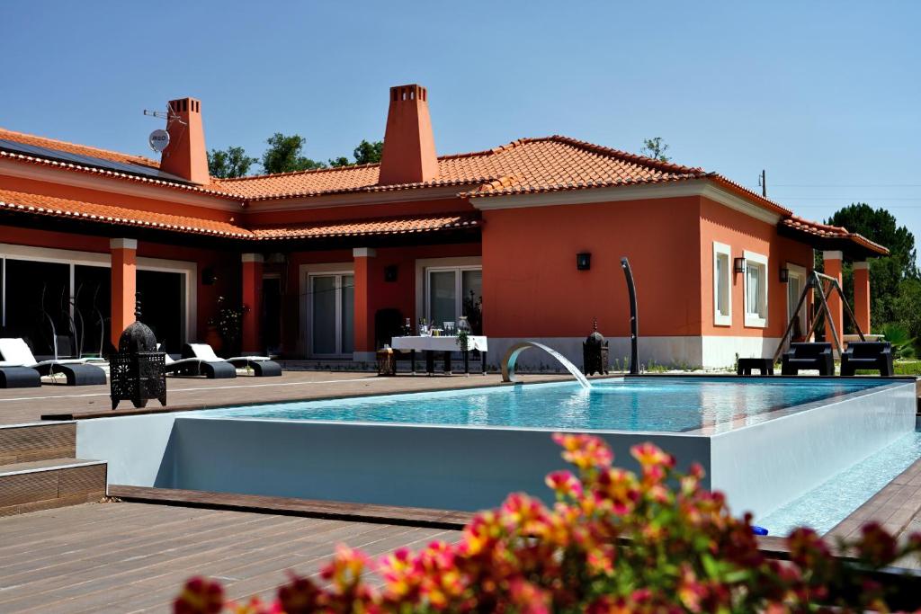 a house with a swimming pool in front of a house at Monte d'Alto in Santo Estêvão