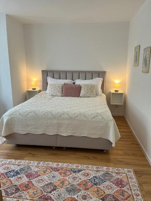 a bedroom with a large bed with two night stands at Ferienwohnung Blerta in Gerolstein