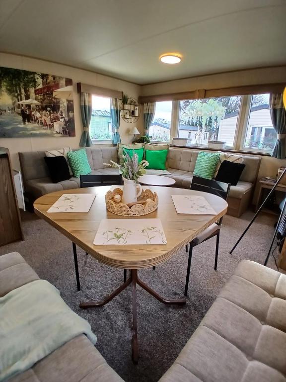 a living room with a table and a couch at Seaton Sands 71 Aberlady in Port Seton