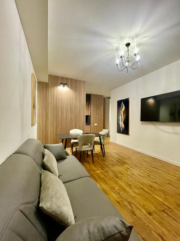 a living room with a couch and a table at Well House Cozy 2BR in Tbilisi City