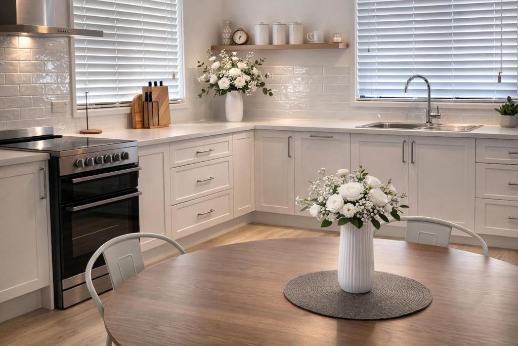 a kitchen with a table with a vase of flowers at Pandora Place in Lightning Ridge