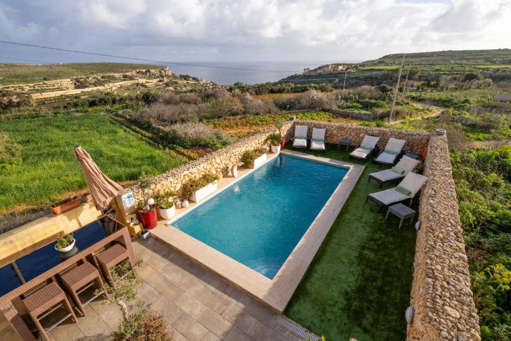 an image of a swimming pool with a view of the ocean at Ajuga Luxury Boutique B&B in Qala
