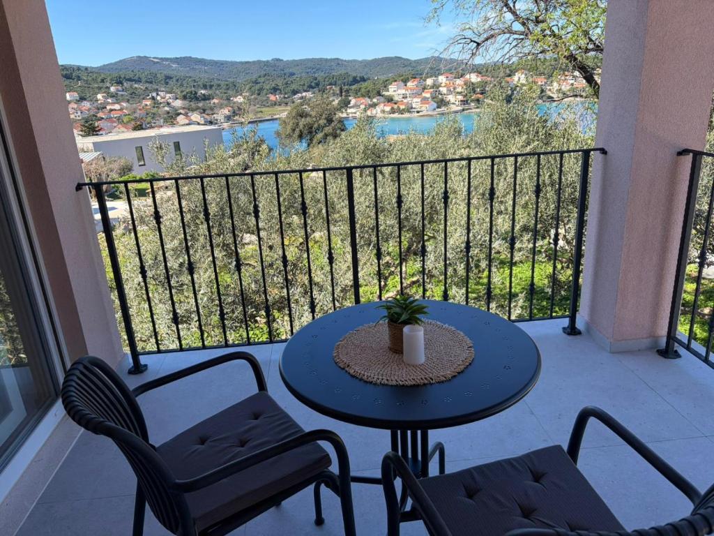 a patio with a table and chairs on a balcony at Apartments Verde in Lumbarda
