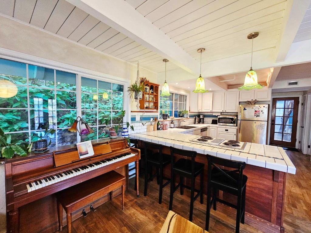 a kitchen with a piano in the middle of a kitchen at Sky Cabin in Aptos