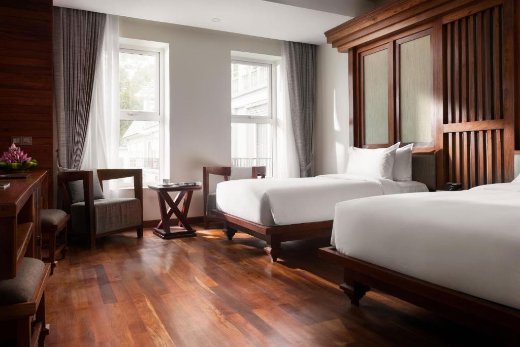 Postel nebo postele na pokoji v ubytování J7 Angkor Hotel