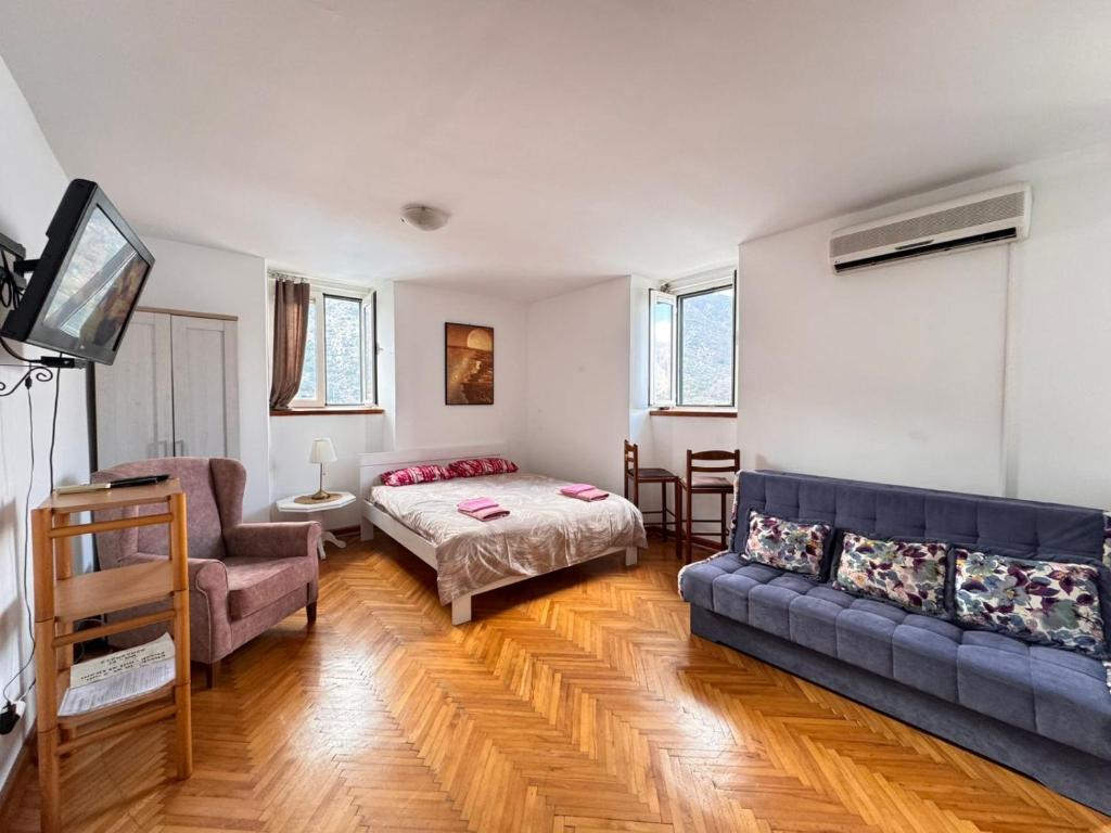 a living room with a couch and a bed at Villa Kamena in Kotor