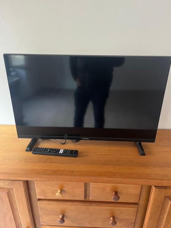 a flat screen tv sitting on top of a dresser at Homeday joffre 3 type f2 in Haguenau