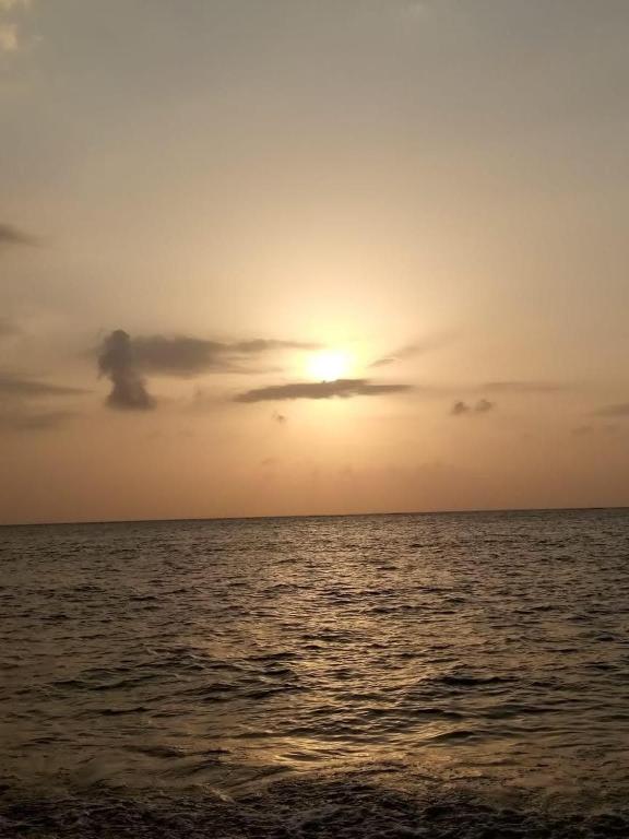 a sunset over the ocean with the sun in the sky at Laminas beach camp in Kilifi