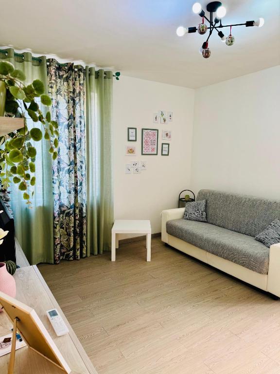a living room with a couch and a table at Casa tua a Pergusa in Pergusa
