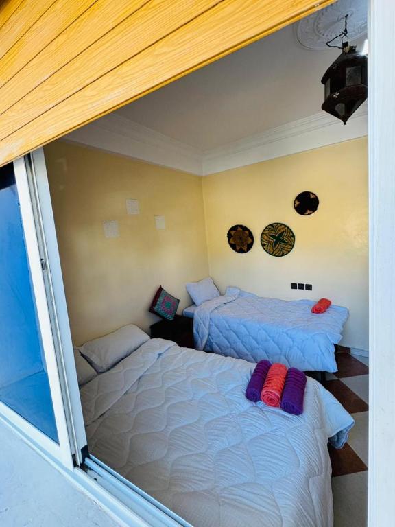 a room with two beds in a room at Vitamin taliouine appartement in Taghazout