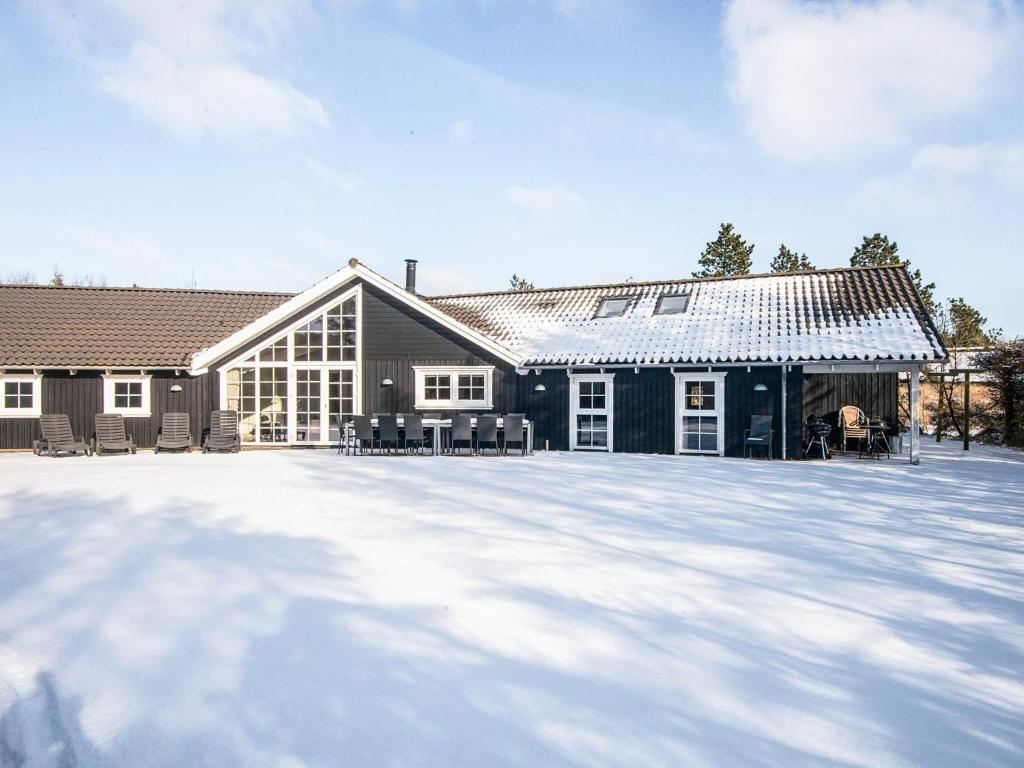 a house with a lot of snow in front of it at 14 person holiday home in Blåvand in Blåvand