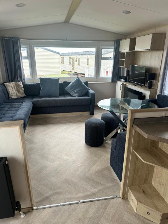 a living room with a couch and a table at Moonstone in Lossiemouth