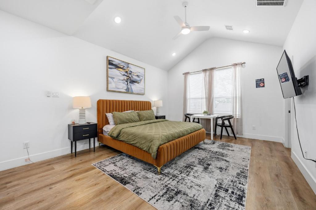a bedroom with a bed and a television in it at The Right Studio @ East Downtown in Houston